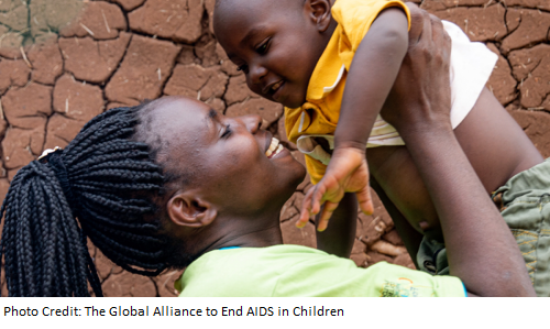 Mother holding up young child