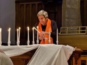 Victoria GRAN Phyllis Webster lights candle at National Day of Remembrance service Dec. 6
