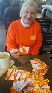 Marlene Merke, Kelowna GRAN, hands out ribbons and info