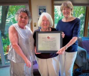 Peggy Edwards (L) and Myrtle Blinn (R) present Maureen Murphy (C) with the Order of GRAN 2024