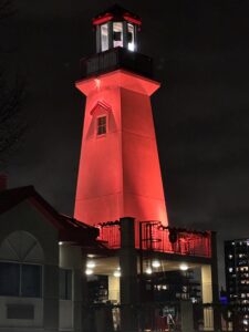 Lighthouse lit up in orange in Port Credit, ON