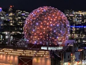 Science World Vancouver lit up in orange and purple