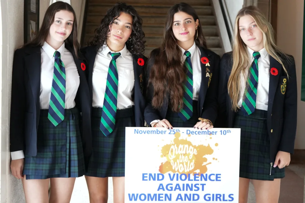 Students at Albert College Belleville hold 16 Days of Activism Sign: End Violence Against Women and Girls