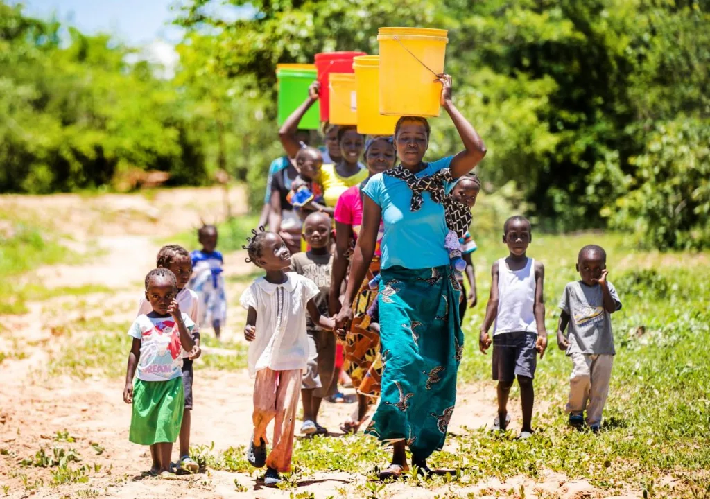 Women and children carry water