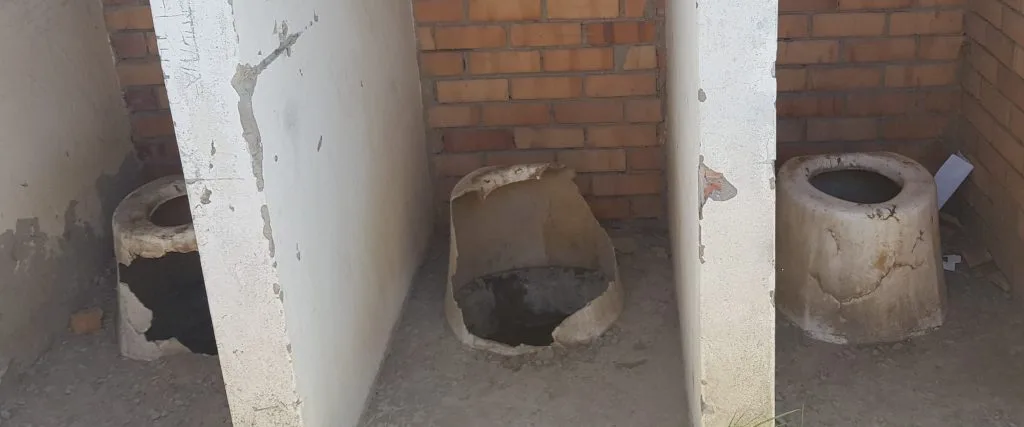 broken and damaged pit toilets